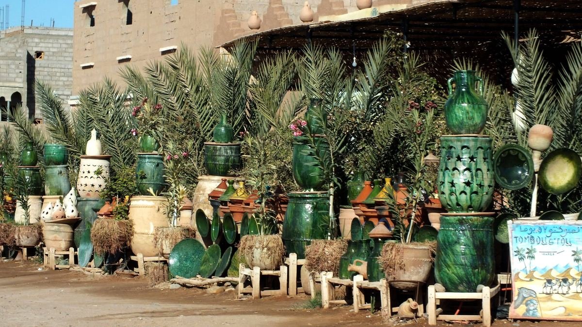 Green glazed pots and jars from Tamegroute displayed outside a workshop