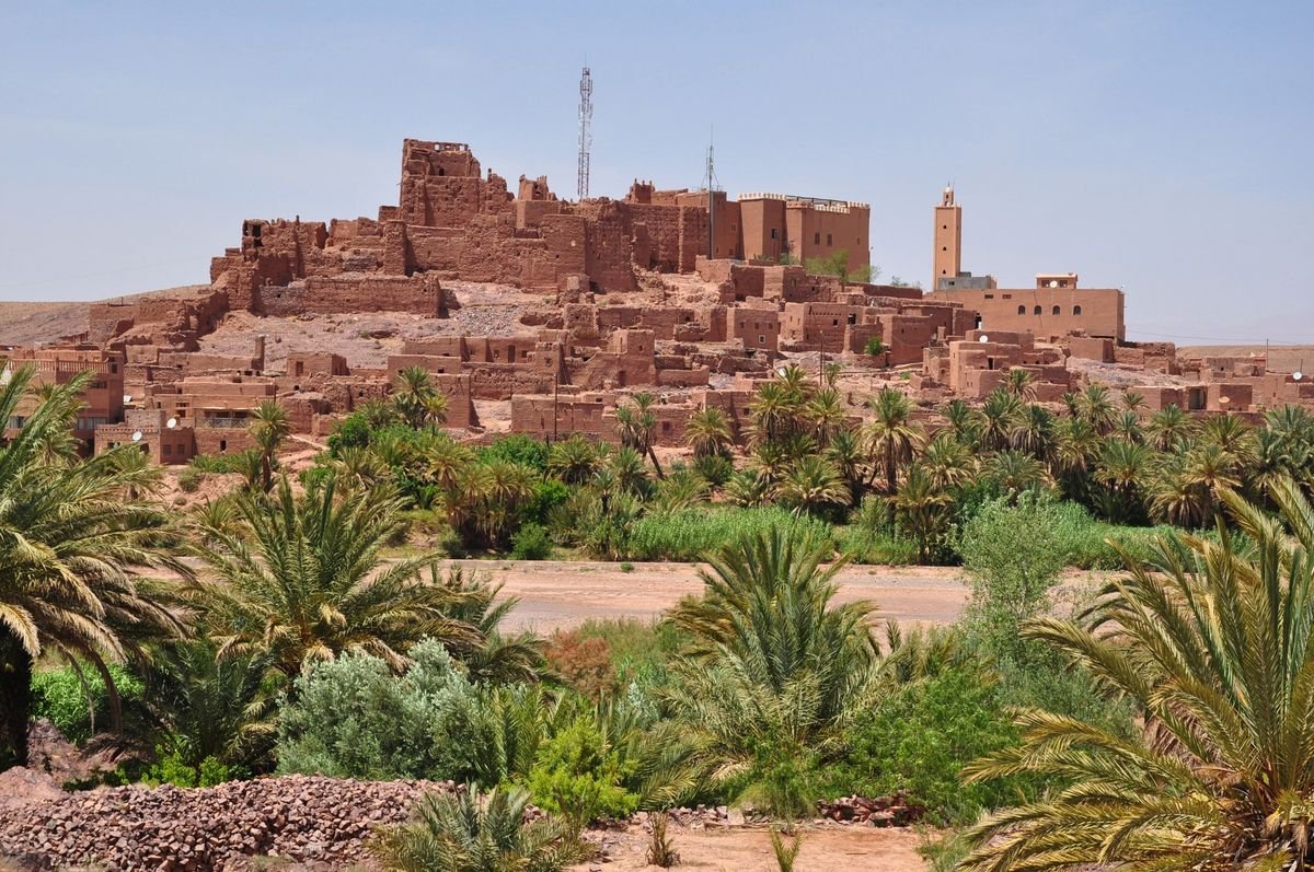 Kasbah Tifoultoute on its hill above palm trees, west of Ouarzazate