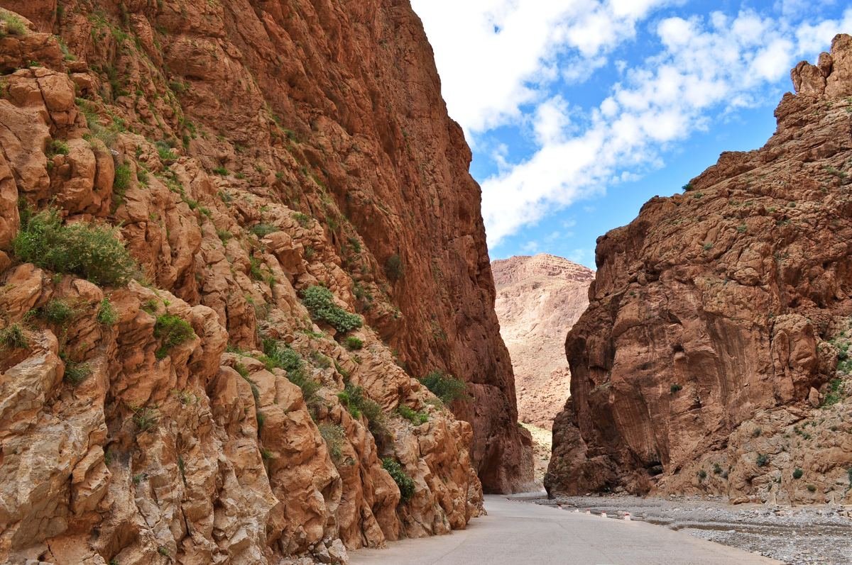 The road running between the red limestone walls of the Todra gorge narrows near Tinghir