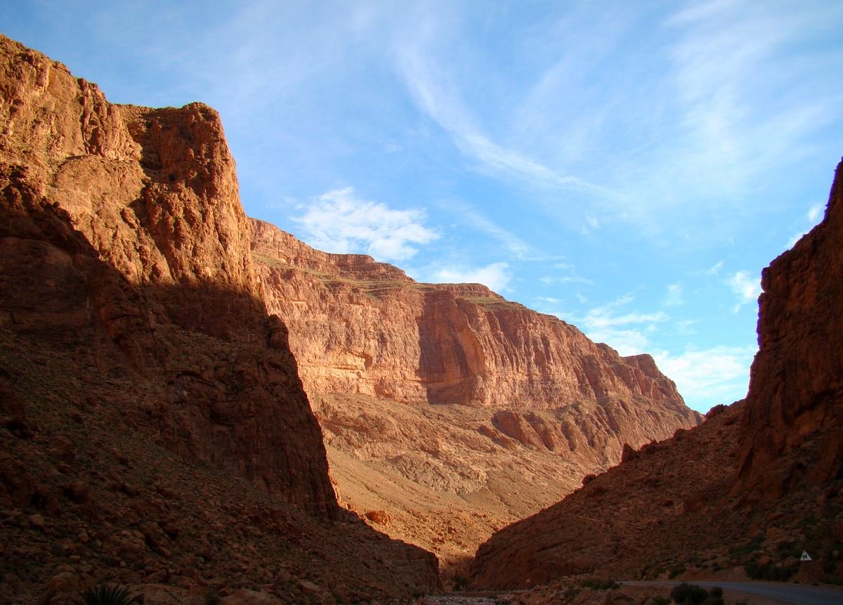 Morning light on the high limestone walls of the Todra gorge just above the narrows