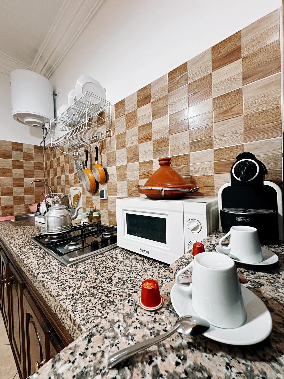Gas hob, microwave, tagine and coffee machine on the granite counter